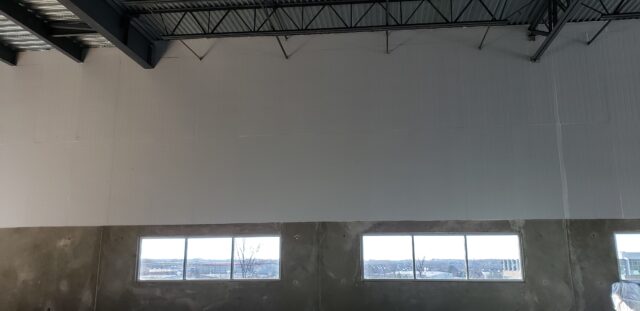 Concrete and Metal warehouse with white Foam Board insulation