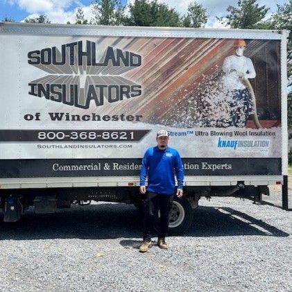 Fernando standing in front of a Southland Insulators truck.