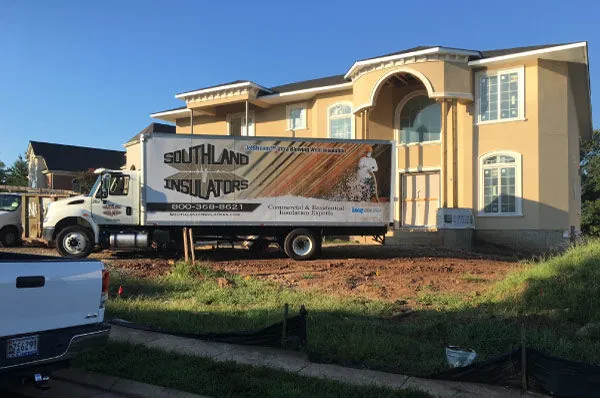 Southland Insulators truck parked at a new home construction project.