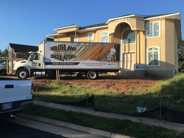 Southland Insulators truck parked at a new home construction project.