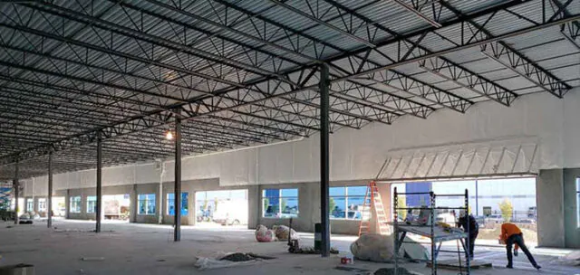 Southland Insulators vinyl-faced fiberglass insulation installed in tilt-up commercial building near scaffolding in Virginia