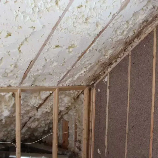 Hybrid open cell spray foam and cellulose in an attic