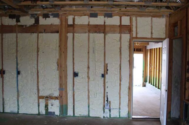 Open cell spray foam in an interior wall with an open door.