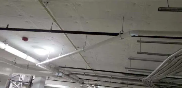 White facing versa board at parking garage ceiling