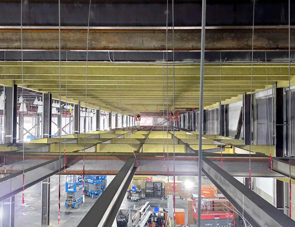Long interior view of Albi cladding fireproofing coating steel ceiling joists throughout a Northern Virginia data center under construction.