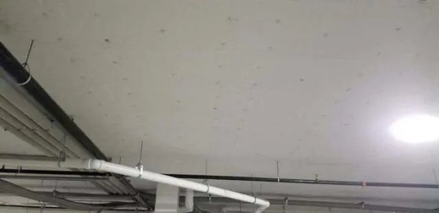 White facing versa board at parking garage ceiling
