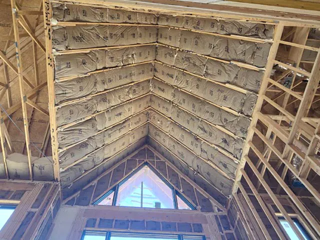 Fiberglass batt insulation installed in vaulted cathedral ceiling.