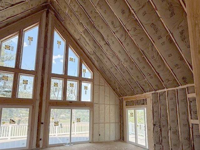 Fiberglass batt insulation in vaulted ceiling rafters.