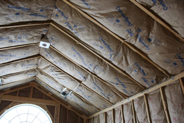 Fiberglass batt insulation in attic joists.