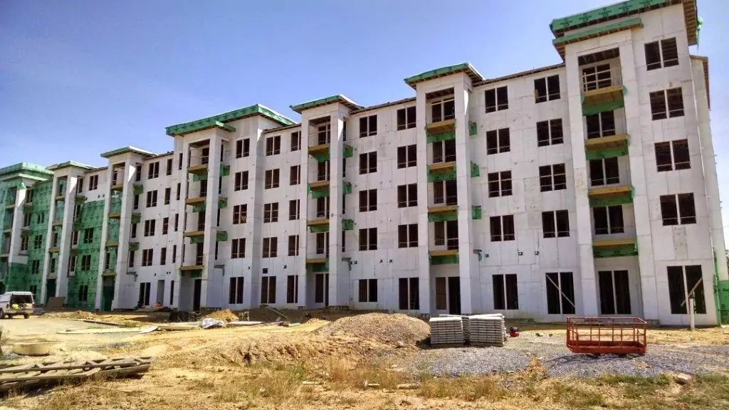 Front of a large multifamily complex under construction.