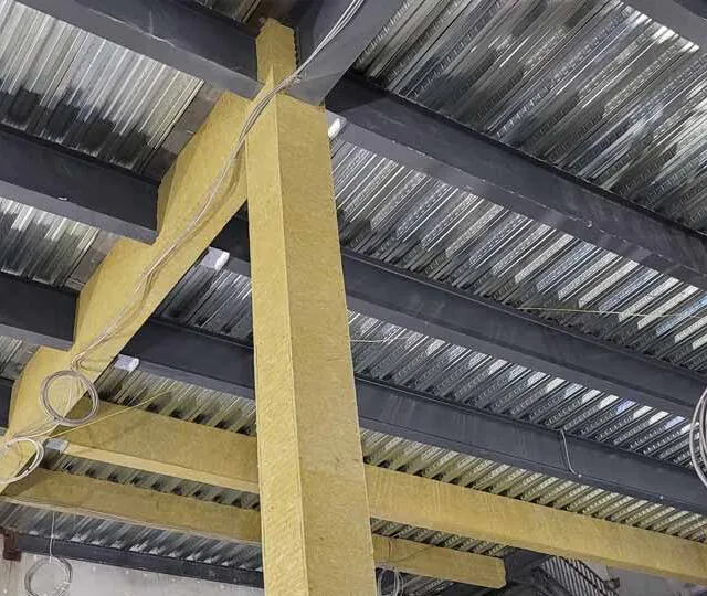 Mineral wool fireproofing wrapped around steel beams at a data center. Mineral wool fireproofing wrapped around steel beams at a data center.