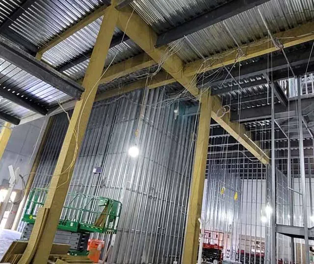 Mineral wool fireproofing applied to steel framing inside a data center under construction. Mineral wool fireproofing applied to steel framing inside a data center under construction.