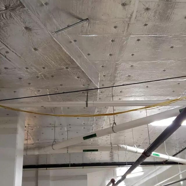 Parking garage ceiling insulated with rigid foam board