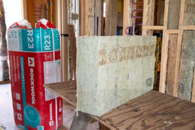 Rockwool mineral wool insulation, one batt in package and another without wrapping.