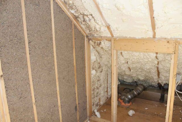 Southland Insulators attic space showing open-cell spray foam insulation along the roofline next to blown-in insulation on a wall cavity in a Northern Virginia home Flags for your review: Material ID (Image 1): The loose-fill material on the attic floor reads as blown-in insulation, but I can't confirm cellulose vs. fiberglass from the photo alone — the texture/color looks more cellulose-like (grayish, fibrous) but please confirm before I lock in the file name/alt text, since this affects both naming and page placement. Material ID (Image 2): Two materials are visible — what looks like open-cell spray foam on the roofline, and a different blown-in/dense-pack material on the wall cavity to the left. Please confirm both materials, and whether the spray foam is open- or closed-cell. Geo-tag: The article specifically calls out both Manassas and Winchester/Clear Brook as service areas rather than Northern Virginia generically. I defaulted to "northern-virginia" since I don't know which job site these came from — let me know if either photo should be tagged to a specific city instead. Page placement: Image 2 pairs well with the "Then the Insulation" section (spray foam vs. blown-in comparison) since it visually shows both methods side by side — flagging in case you want it split into two separate crops/images for the blown-in and spray foam sections individually. 