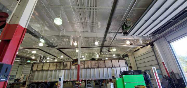 White vinyl PSK faced insulation on ceiling above truck bay.