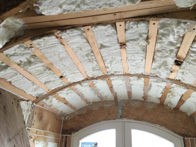Curved ceiling with spray foam insulation