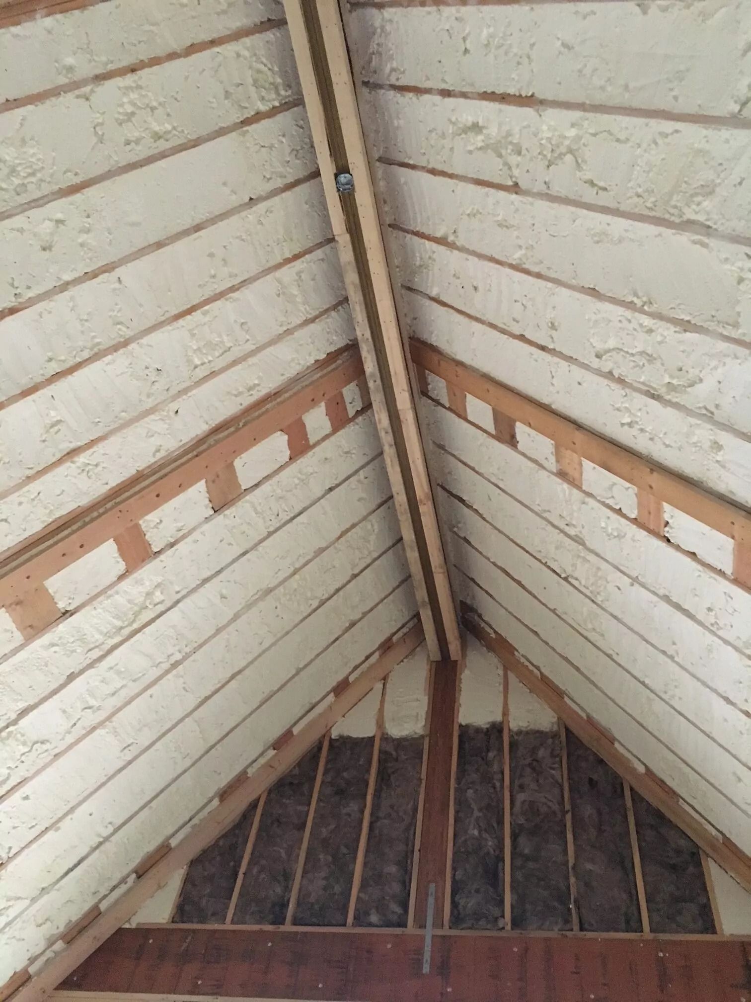 Spray foam insulation in the ceiling of a peaked attic.