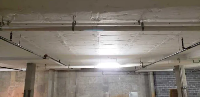 White facing versa board at parking garage ceiling