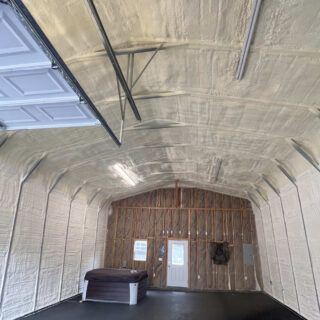 Spray foam and fiberglass batt insulation installed in a metal garage.