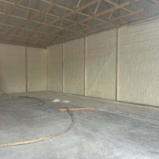 Spray foam insulation installed in the walls of a garage.