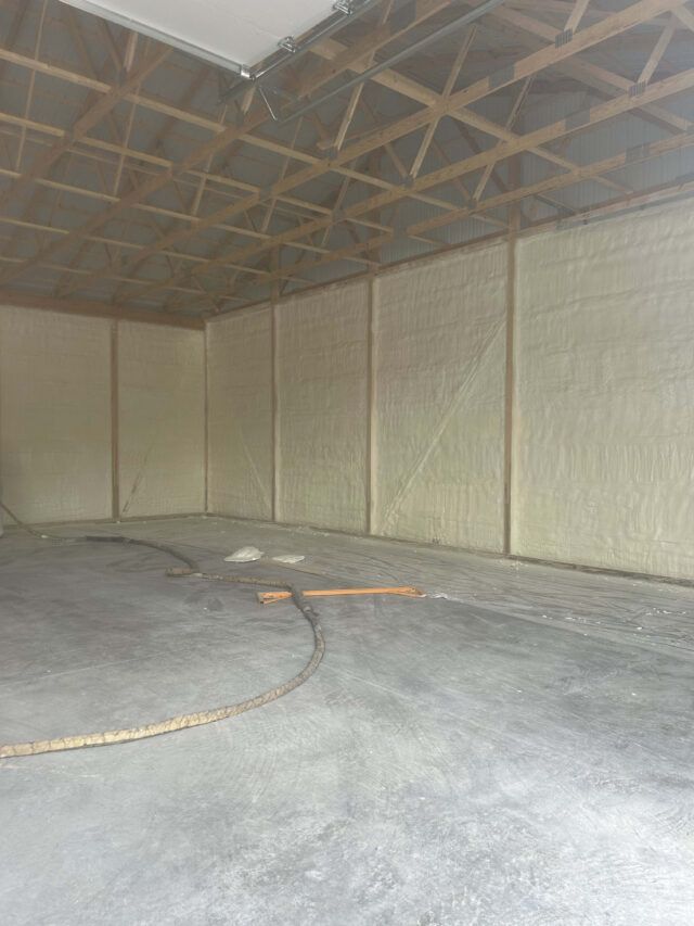 Spray foam insulation installed in the walls of a garage.